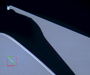 High-resolution optical capture showing edge-level defect detection on specular surfaces.
